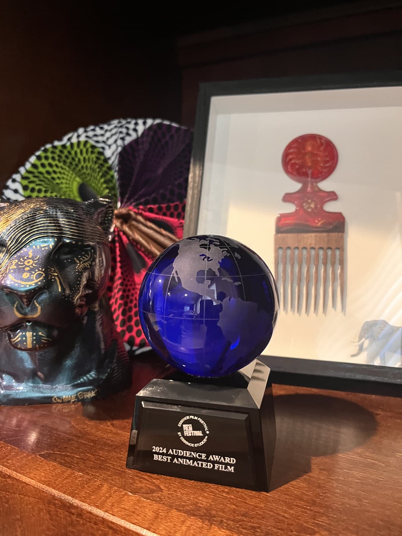 The 2024 Essence Film Festival Audience Award for Best Animated Film won by BrakoVerse Media, displayed beside the Lost Comb of Mawu poster